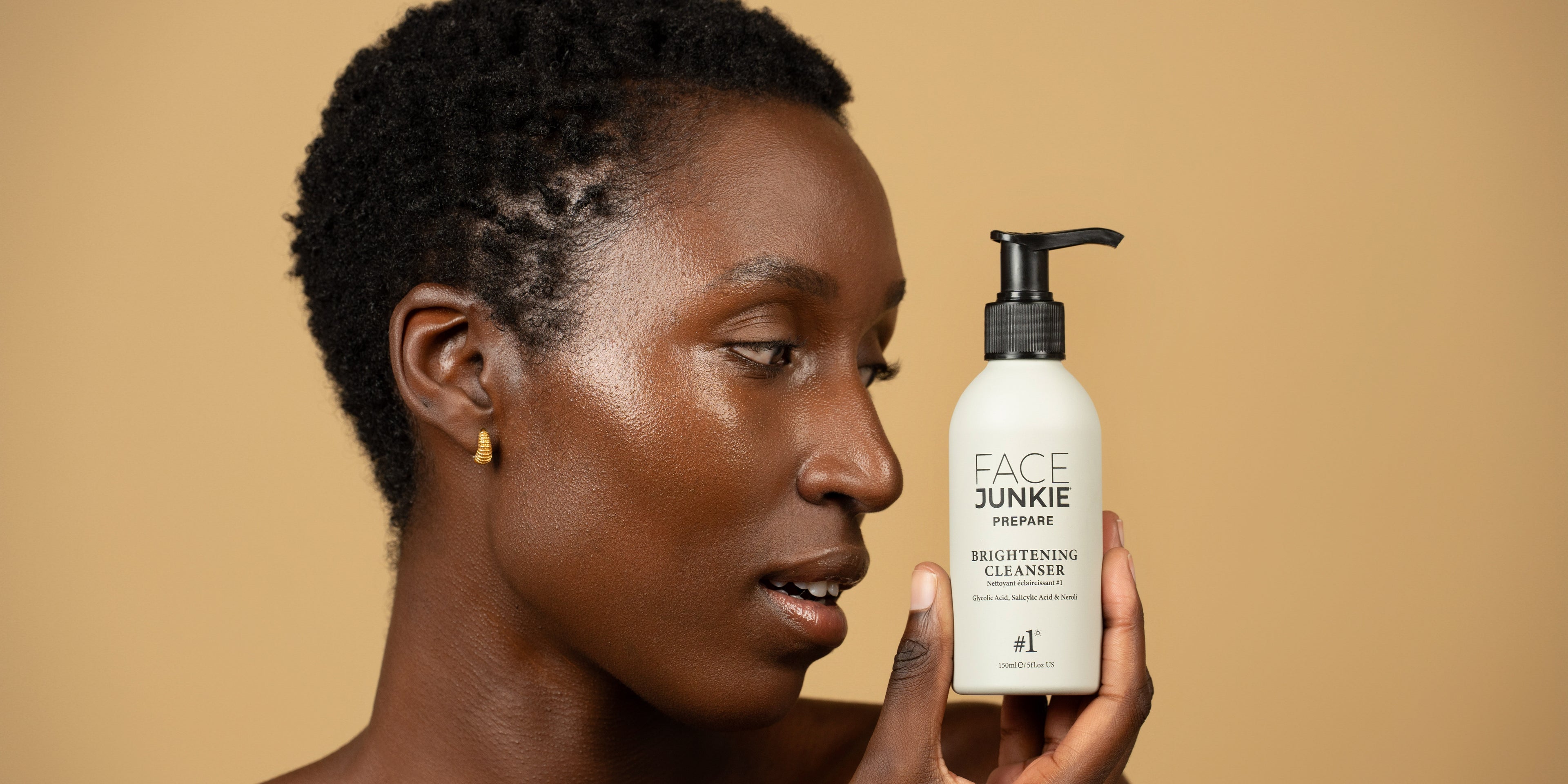 Picture of a model holding a Face Junkie #1 Brightening Cleanser